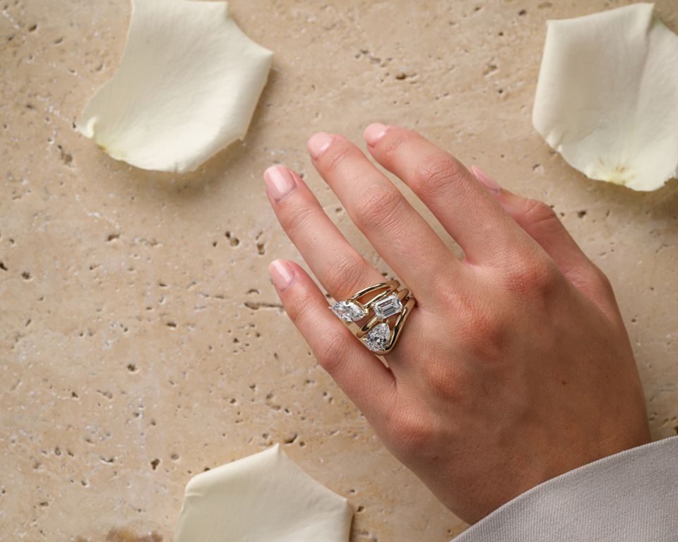 yellow gold engagement rings, necklace and earrings on woman